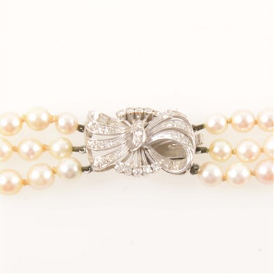 Lot 229 - A three row cultured pearl necklace with diamond clasp