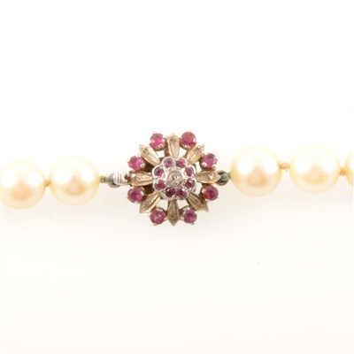 Lot 233 - A cultured pearl necklace with ruby fastener.