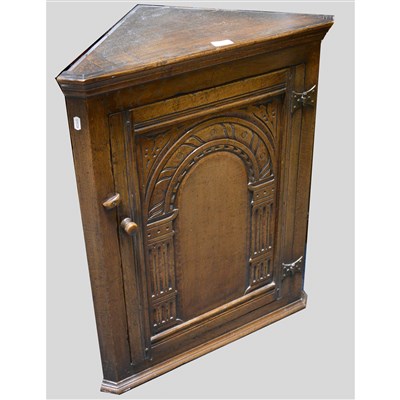 Lot 424 - A reproduction oak hanging corner cupboard, labelled Maple