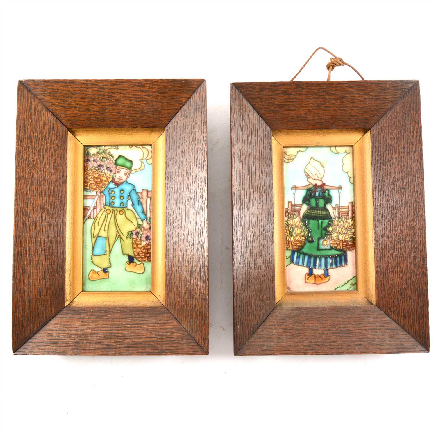 Lot 120 - Two framed Victorian art pottery tiles, tubelined with Dutch children