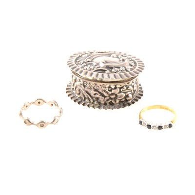 Lot 212 - An 18 carat gold sapphire and diamond ring, a silver pill box and a silver ring.