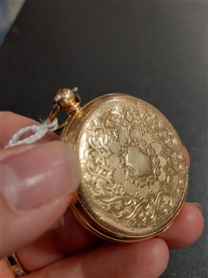 Lot 431 - An 18K open face fob watch.