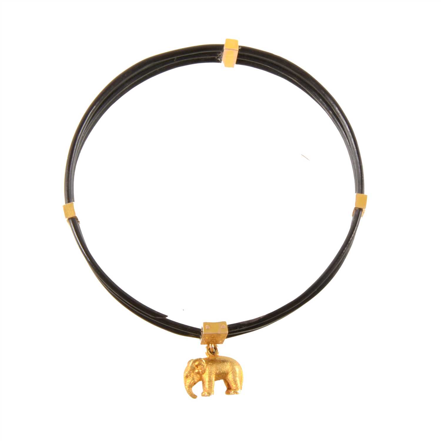 Lot 347 - A three strand elephant hair bangle with four gold coloured retainers and elephant charm