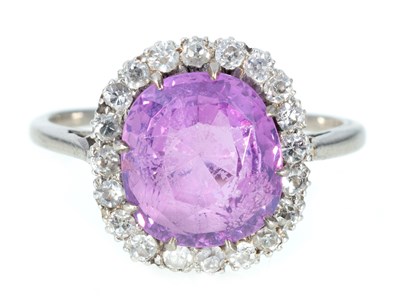 Lot 197 - A pink sapphire and diamond cluster ring.