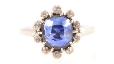 Lot 198 - A sapphire and diamond cluster ring.
