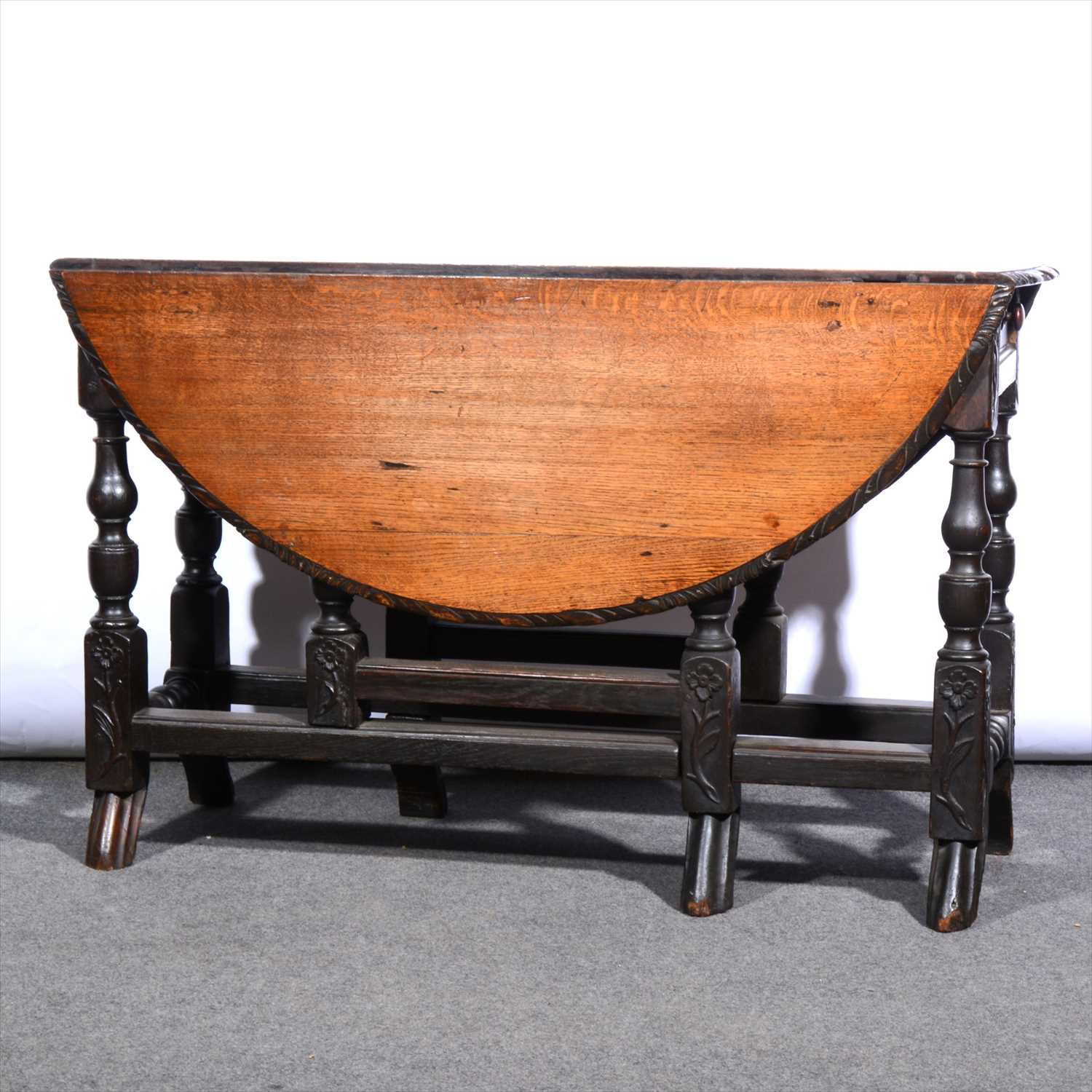 Lot 584 - A carved oak gateleg table, ...