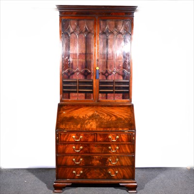 Lot 627 - A George III style mahogany bureau bookcase, ..