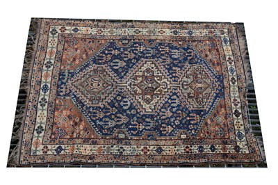 Lot 483 - A Qashqai rug, three joined lozenge medallions on a blue ground, ...