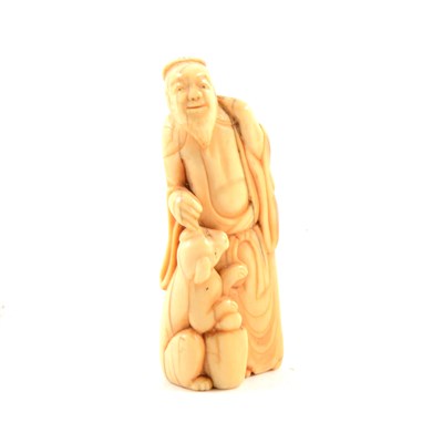 Lot 79 - Carved ivory netsuke of an elder with dog