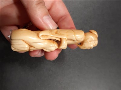 Lot 79 - Carved ivory netsuke of an elder with dog