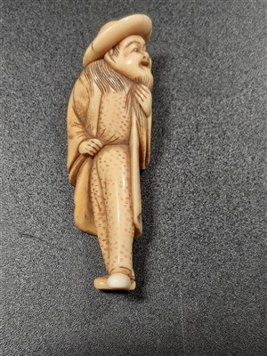 Lot 78 - Carved ivory netsuke, elder wearing a hat