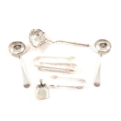 Lot 198 - Three silver sugar tongs, two silver sauce ladles, Sterling silver caddy spoon, and an early toddy ladle (no handle).