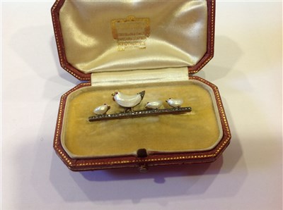 Lot 161 - A pearl and diamond  hen and chicks brooch.