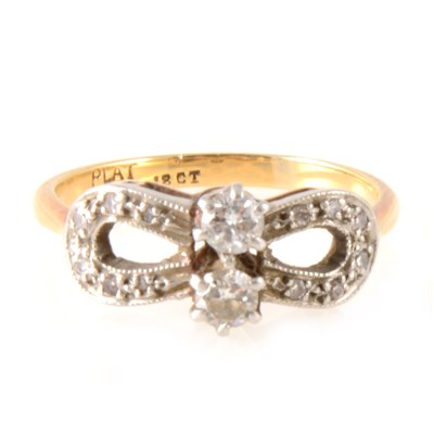 Lot 240 - A bow design diamond set dress ring.