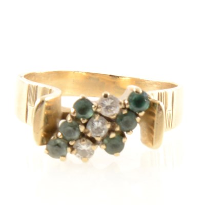 Lot 225 - A diamond and green stone dress ring