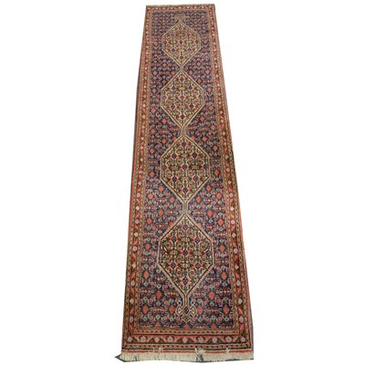 Lot 485 - A Persian patterned runner, with four joined lozenge medallions ...