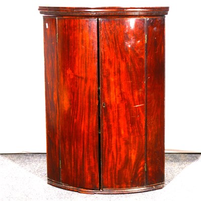 Lot 361 - A George III mahogany cylinder front hanging corner cupboard