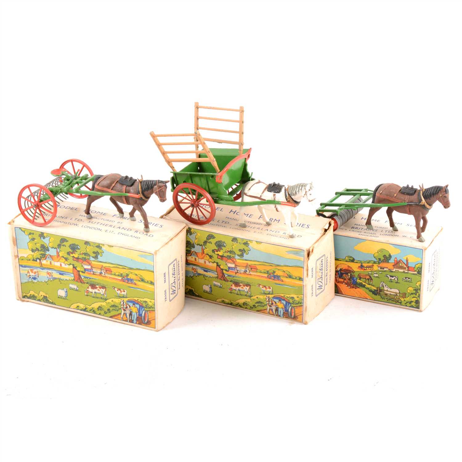 Lot 91 - Britains Farming Toys; no.9506 farm rake, no.9504 farm roller, no.9505 Tumbrel cart, all boxed.