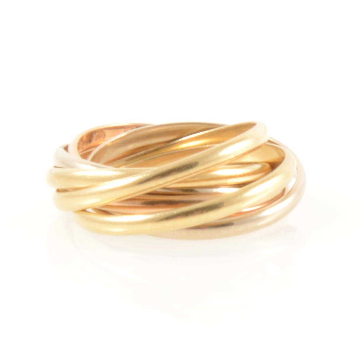 Lot 213 - Cartier - An 18 carat gold tri-colour six band rolling ring.