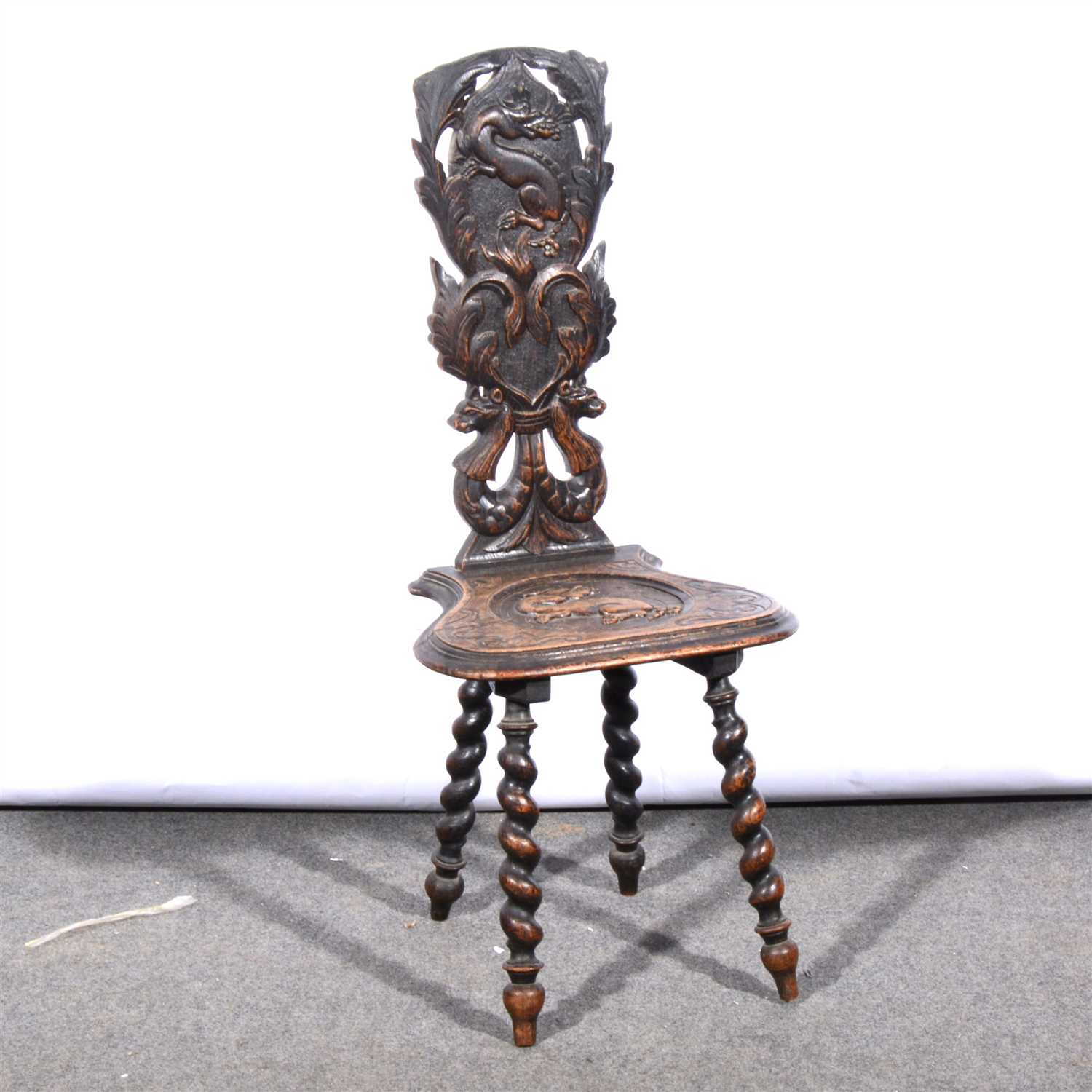 Lot 664 - A carved oak hall chair