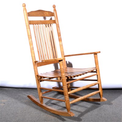 Lot 586 - A reproduction Colonial style stained wood rocking chair, ...