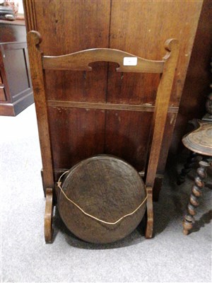 Lot 665 - A bronze gong, diameter 34cm, on an oak stand, height 74cm.