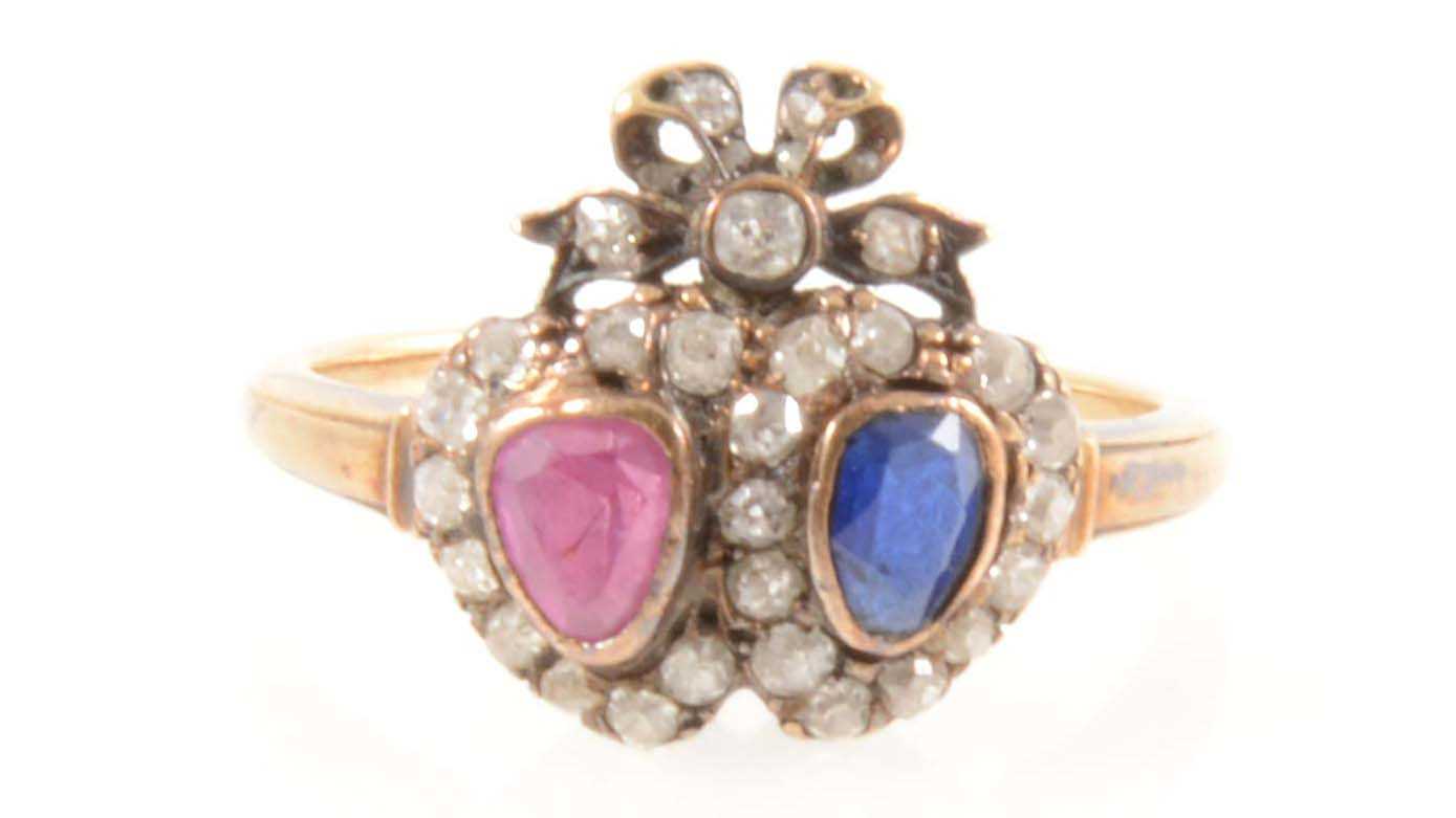 Lot 201 - A sapphire, ruby and diamond double heart ring.