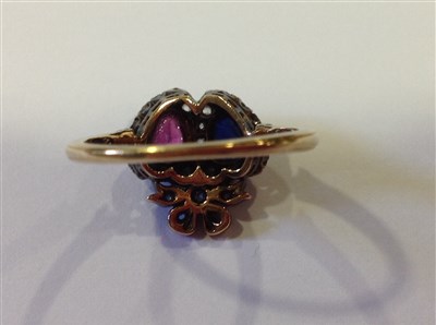 Lot 201 - A sapphire, ruby and diamond double heart ring.