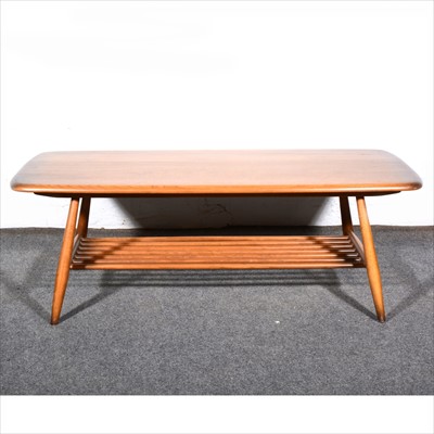 Lot 259 - A stained elm coffee table by Ercol.