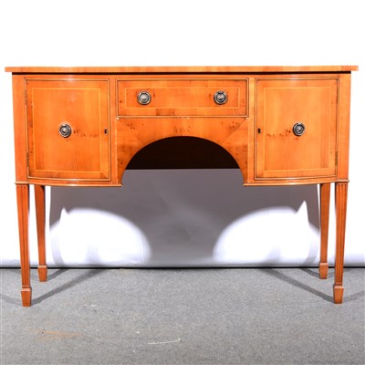 Lot 643 - A reproduction yew wood sideboard, in the...