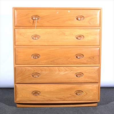 Lot 255 - Ercol, an elm chest of five drawers.