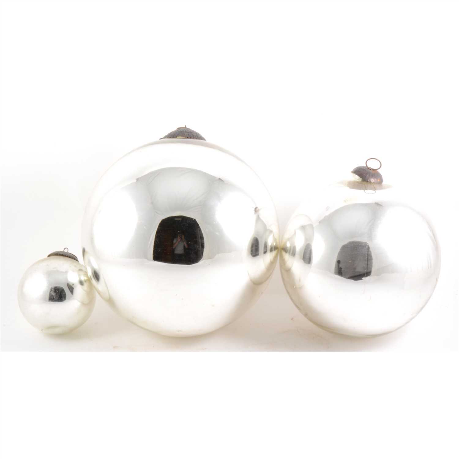 Lot 143 - Three graduating silvered witches balls