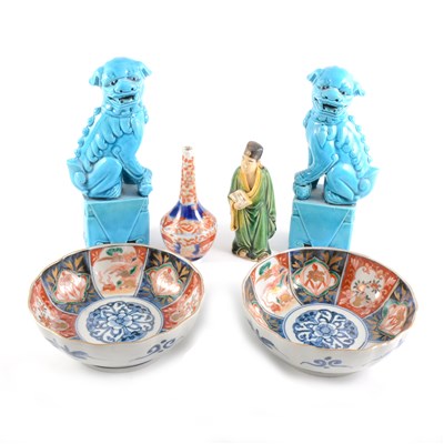 Lot 44 - A pair of Chinese turquoise glazed models of Temple Lions, ...