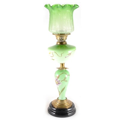 Lot 197 - A green tinted opaque glass oil lamp, ...