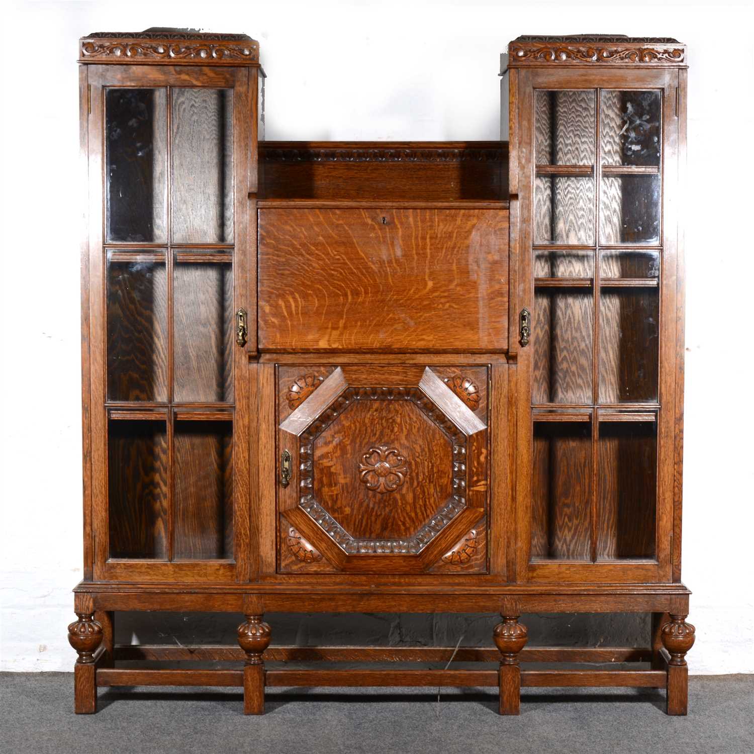 Lot 383 - Oak side-by-side bureau bookcase, carved...