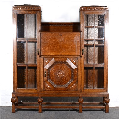 Lot 383 - Oak side-by-side bureau bookcase, carved...