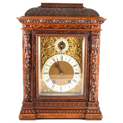 Lot 202 - A late Victorian figured and carved walnut mantel clock, ...
