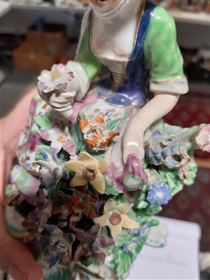 Lot 77 - A Derby figure of a young lady, with flowers, ...