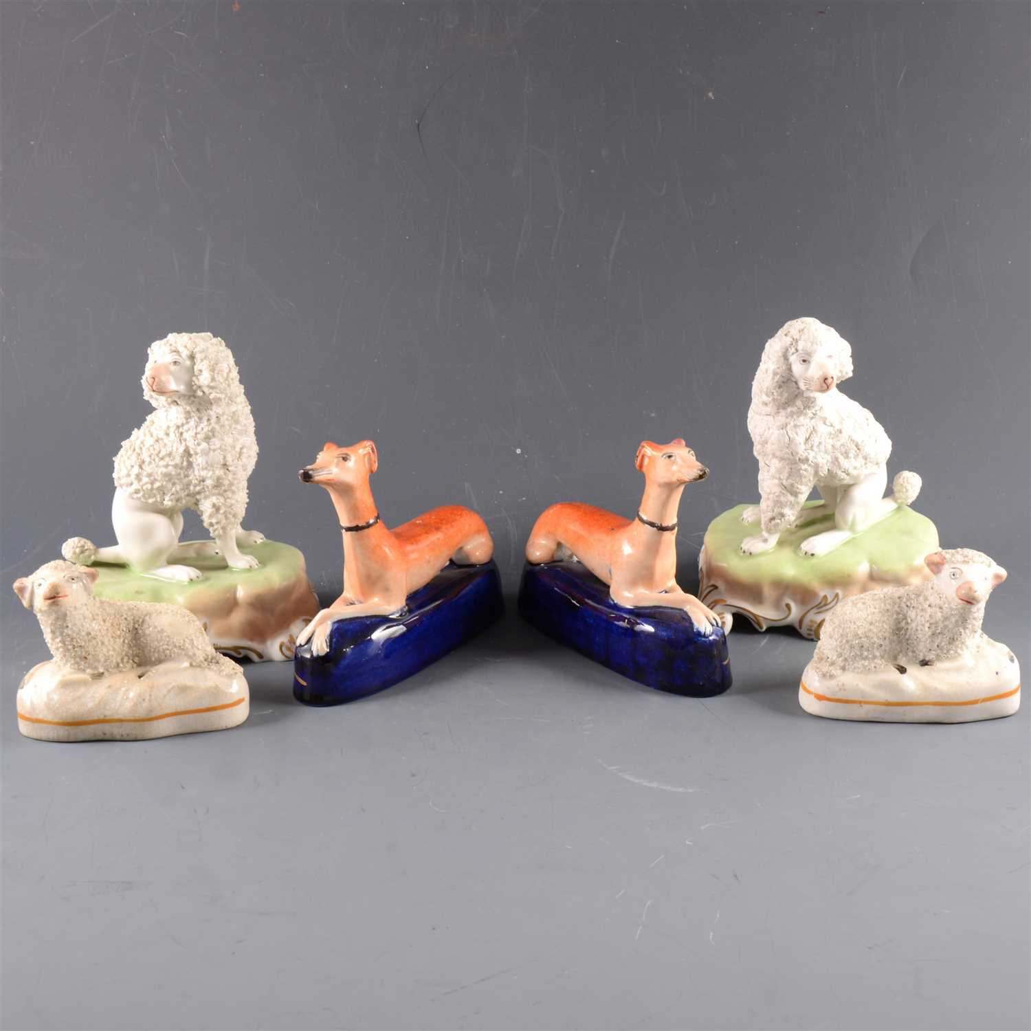Lot 48 - A pair of Dresden porcelain models of seated poodles, ...