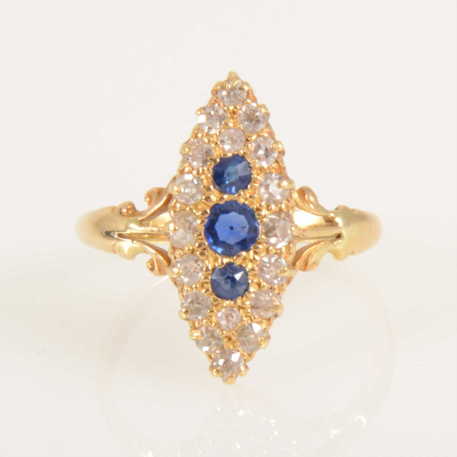 Lot 670 - A sapphire and diamond marquise cluster ring.