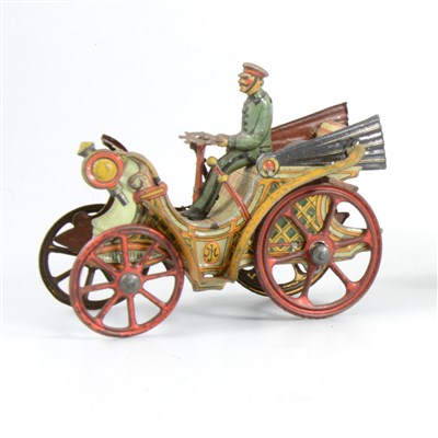 Lot 117 - An early 20th Century tin-plate vintage motor car, with spoked wheels, driver and steering wheel, 9cm long.