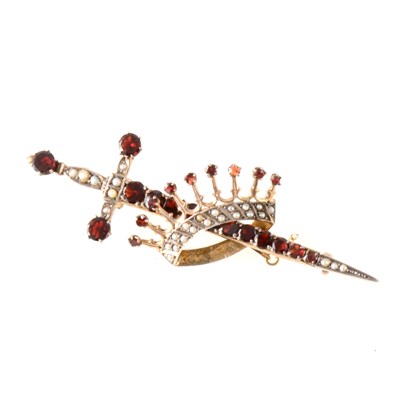 Lot 370 - A sword and crown brooch set with garnets and seed pearls.