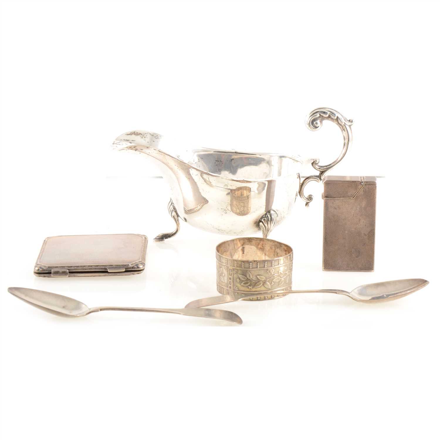 Lot 197 - A silver sauce boat, powder compact, a silver Dunhill lighter four Irish spoons.