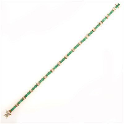 Lot 677 - An emerald and diamond line bracelet.