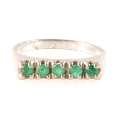Lot 273 - An emerald half hoop ring.