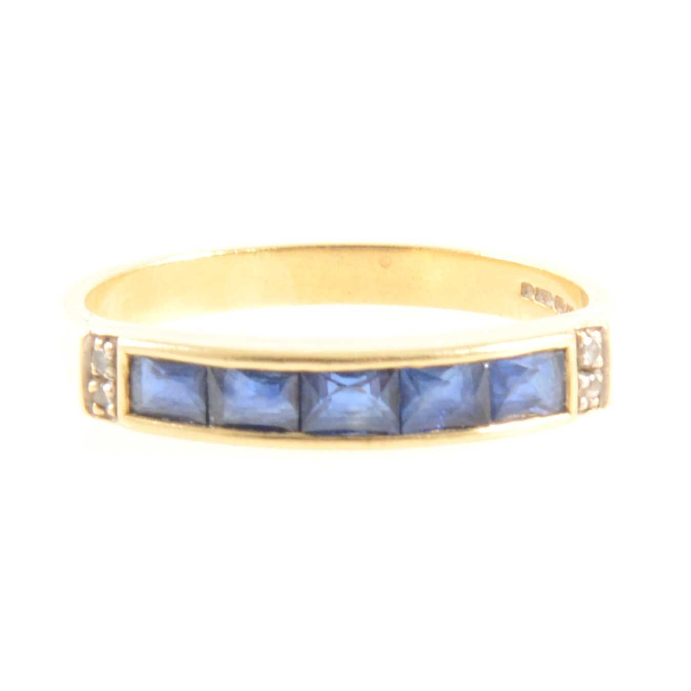 Lot 265 - A sapphire and diamond half eternity ring.