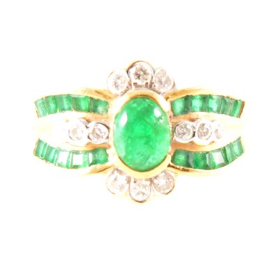 Lot 269 - An emerald and diamond multi stone dress ring.