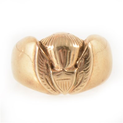 Lot 297 - A 9 carat yellow gold signet ring with wing and shield emblem.