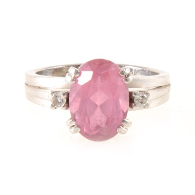 Lot 261 - A pink tourmaline and diamond dress ring.