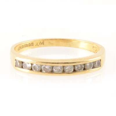 Lot 387 - A diamond half eternity ring.